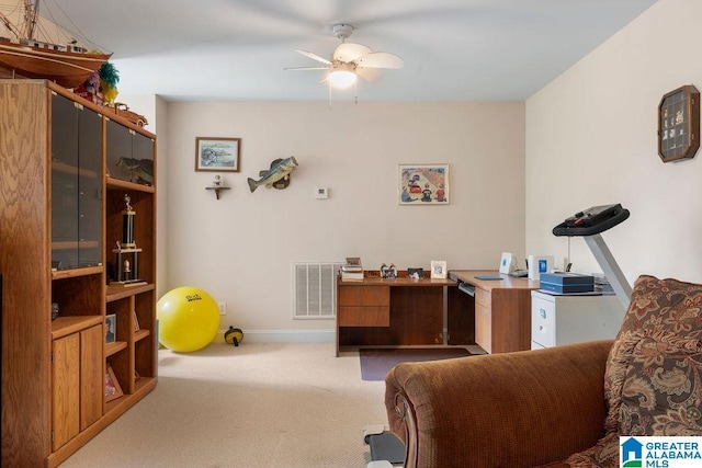 office space featuring a ceiling fan, visible vents, carpet floors, and baseboards