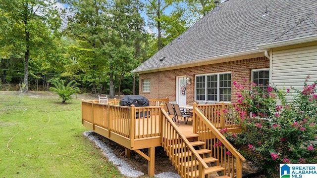 wooden terrace with a grill, stairway, and a lawn
