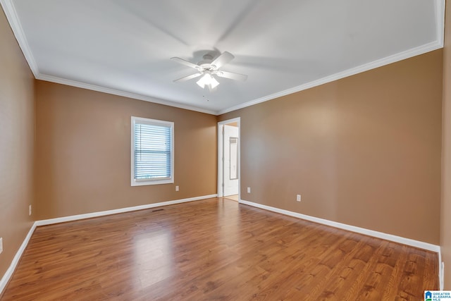 spare room with ornamental molding, hardwood / wood-style flooring, and ceiling fan