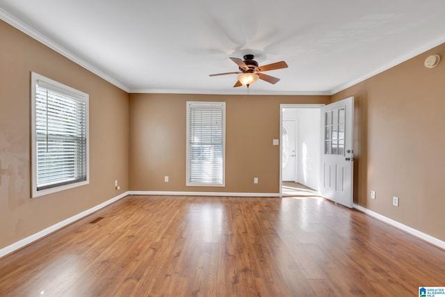 spare room featuring ceiling fan, ornamental molding, and light hardwood / wood-style floors