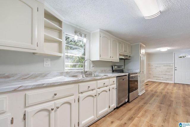 kitchen with appliances with stainless steel finishes, a textured ceiling, sink, and light hardwood / wood-style floors