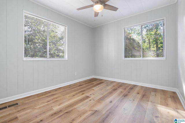 spare room with crown molding, ceiling fan, and light hardwood / wood-style floors