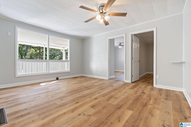 unfurnished room with crown molding, ceiling fan, and light wood-type flooring