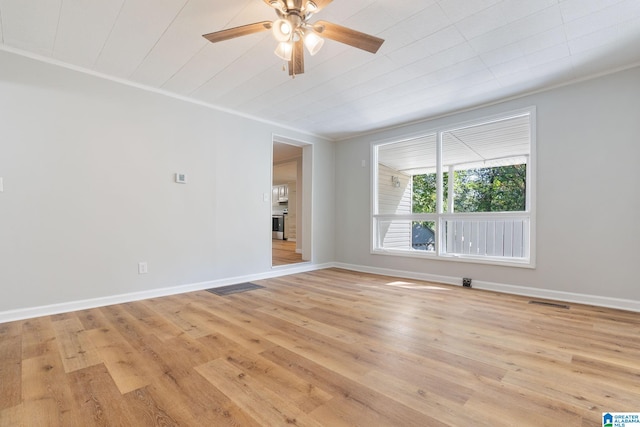 empty room featuring ceiling fan, light hardwood / wood-style floors, and ornamental molding