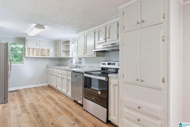 kitchen with light wood-type flooring, white cabinetry, a textured ceiling, stainless steel appliances, and sink