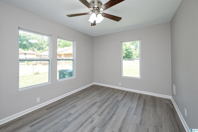 unfurnished room with hardwood / wood-style floors and ceiling fan