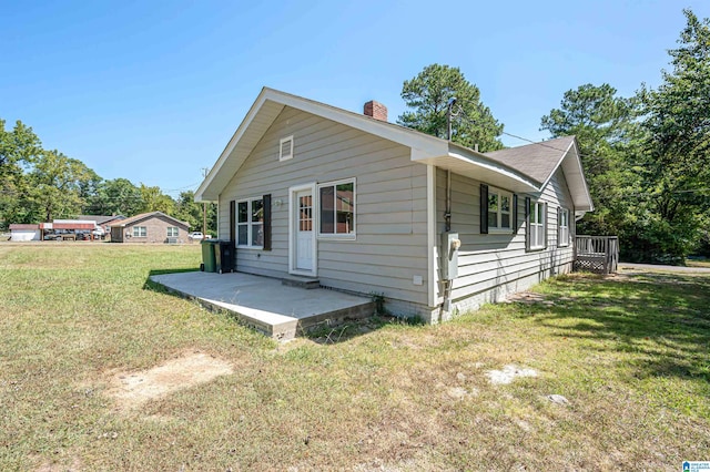 view of side of home featuring a yard