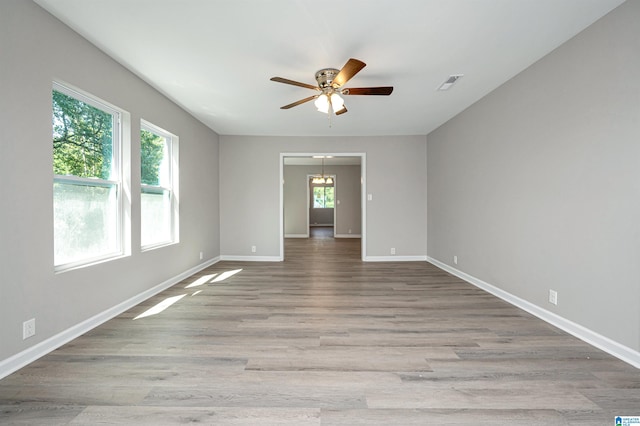 spare room with ceiling fan and light wood-type flooring