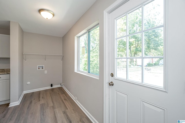 washroom featuring hookup for a washing machine, plenty of natural light, hookup for a gas dryer, and hardwood / wood-style floors