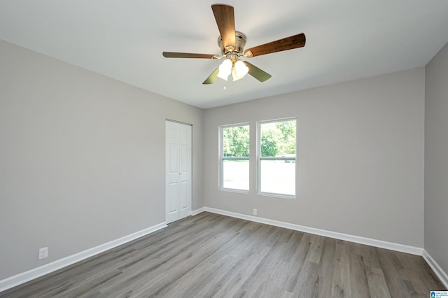 unfurnished room with ceiling fan and hardwood / wood-style flooring