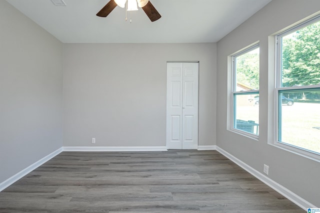 unfurnished room with wood-type flooring and ceiling fan