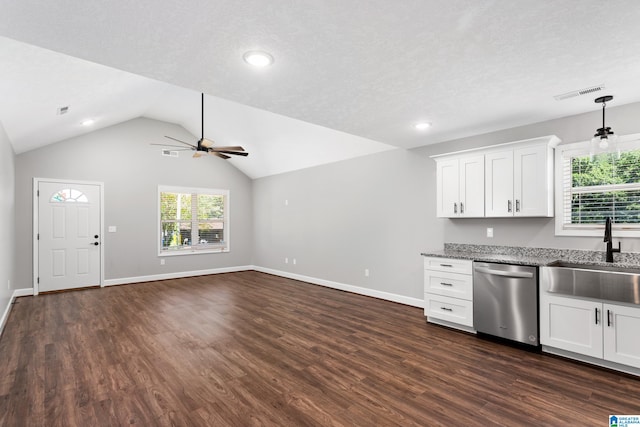 kitchen featuring vaulted ceiling, dark hardwood / wood-style floors, stainless steel dishwasher, sink, and ceiling fan