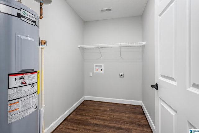 clothes washing area with hookup for a washing machine, dark hardwood / wood-style flooring, electric dryer hookup, and electric water heater