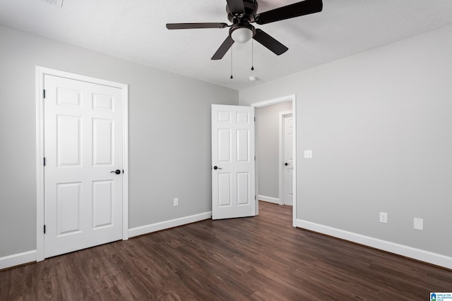 unfurnished bedroom with dark wood-type flooring and ceiling fan