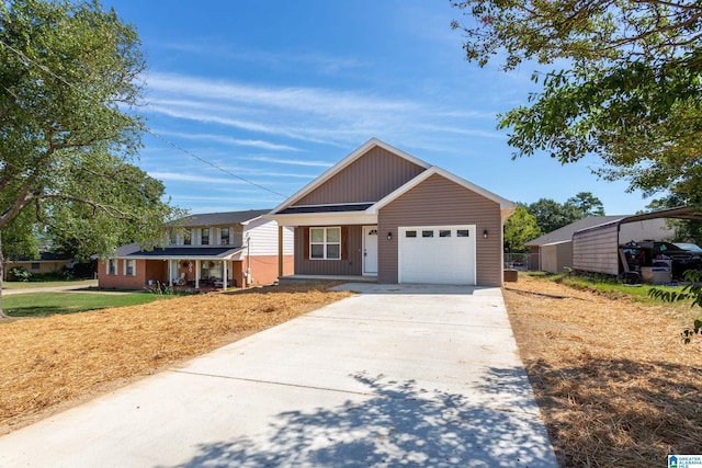 view of front of home with a garage, covered porch, and a front yard