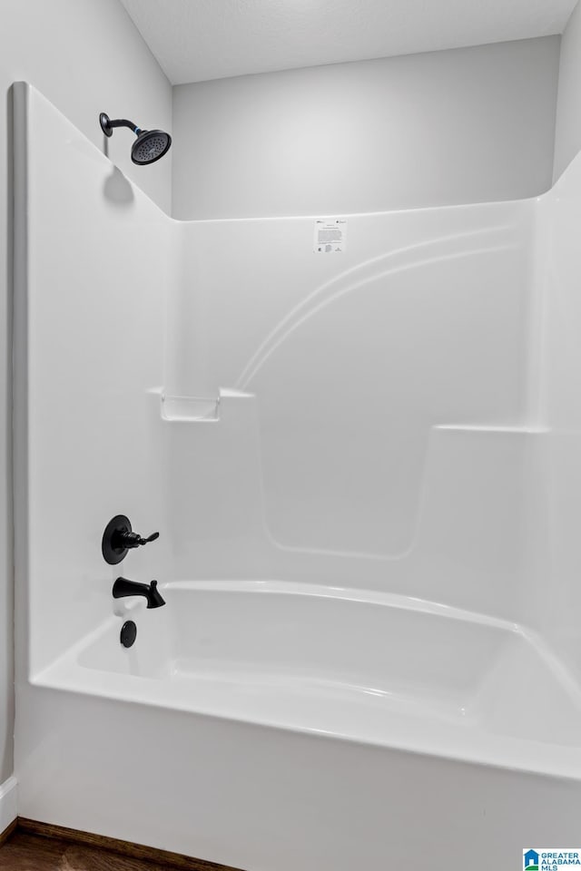 full bath with wood finished floors and bathtub / shower combination