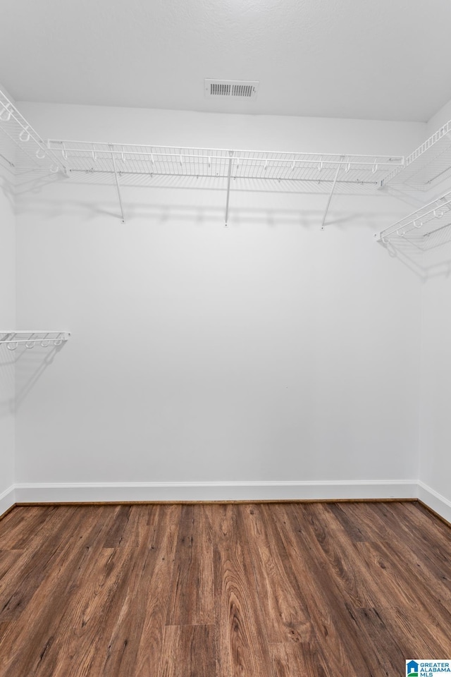 walk in closet featuring visible vents and wood finished floors