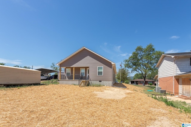 back of property featuring a porch, central AC, and a carport