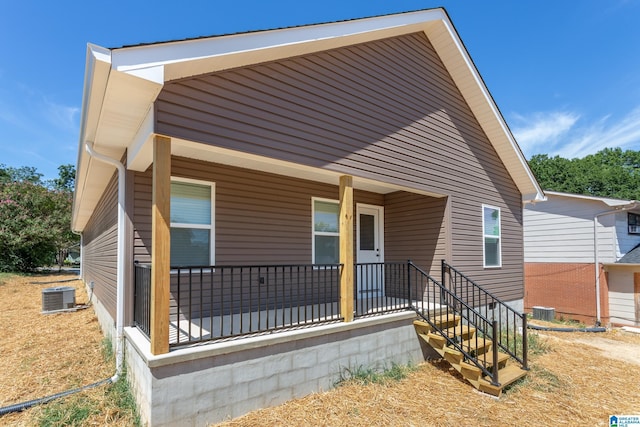 view of front facade featuring a porch and central AC