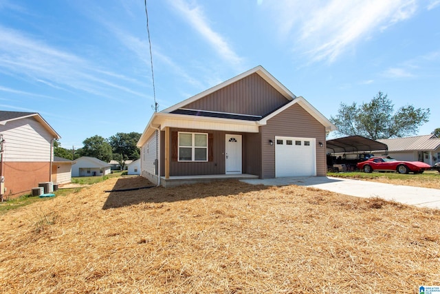 view of front of property featuring a garage, a carport, a porch, and central AC