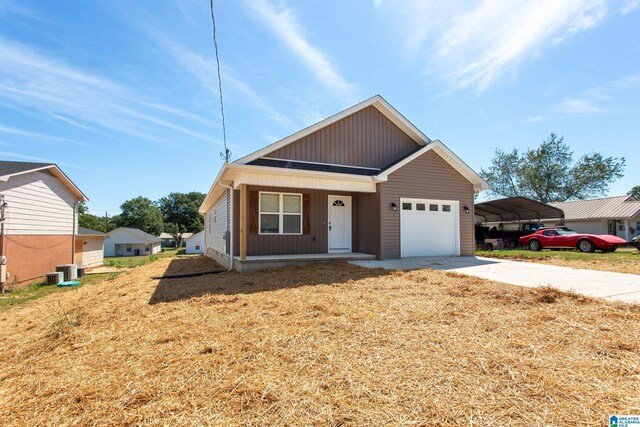 ranch-style home featuring a garage, covered porch, cooling unit, driveway, and a carport
