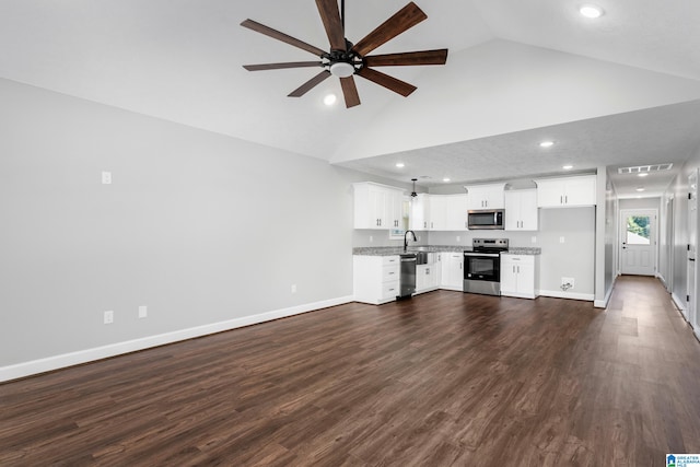 unfurnished living room featuring ceiling fan, dark hardwood / wood-style flooring, and sink