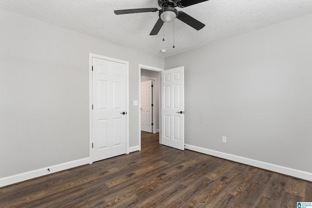 unfurnished bedroom featuring a textured ceiling, ceiling fan, and dark hardwood / wood-style flooring