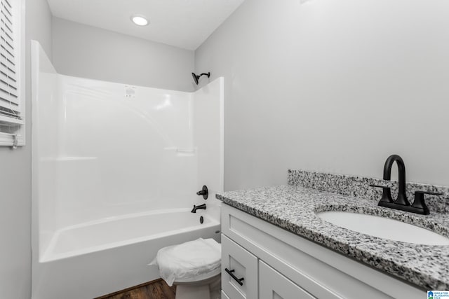 full bathroom featuring vanity, toilet, shower / bathtub combination, and hardwood / wood-style floors