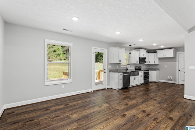 kitchen featuring a textured ceiling, decorative light fixtures, stainless steel appliances, dark wood-type flooring, and white cabinets