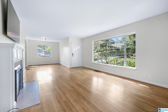 unfurnished living room featuring light hardwood / wood-style flooring