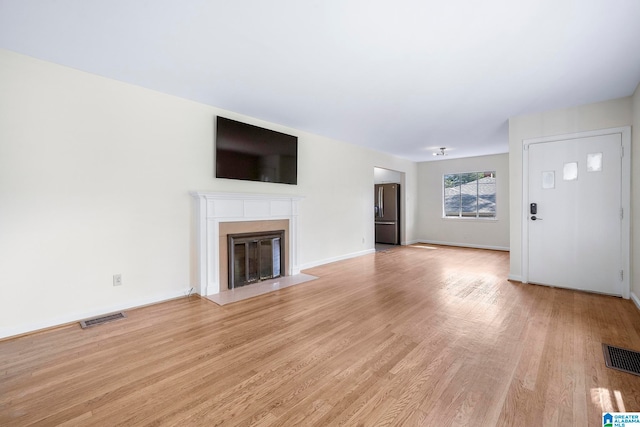 unfurnished living room with light hardwood / wood-style floors