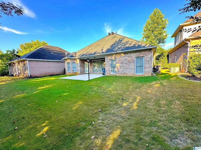 back of house with a patio area, a yard, and cooling unit