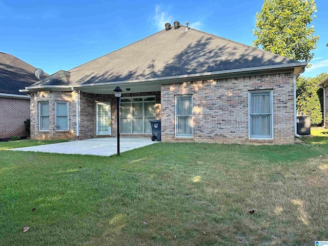 rear view of house featuring central AC, a yard, and a patio