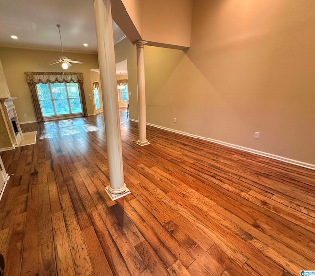 unfurnished living room with ceiling fan, crown molding, a fireplace, and hardwood / wood-style floors