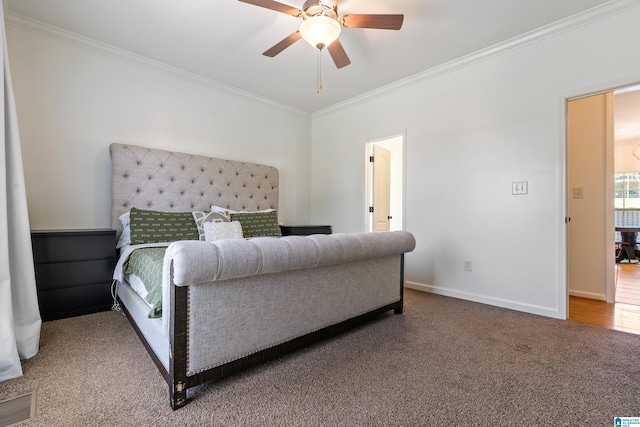 carpeted bedroom featuring ornamental molding and ceiling fan