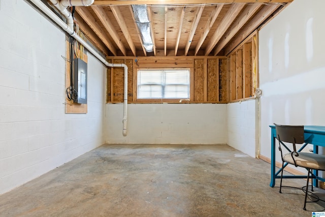 interior space with electric panel and concrete flooring