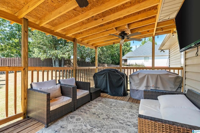 deck with grilling area and ceiling fan