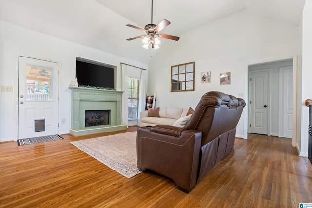 living room with ceiling fan, dark hardwood / wood-style floors, and high vaulted ceiling