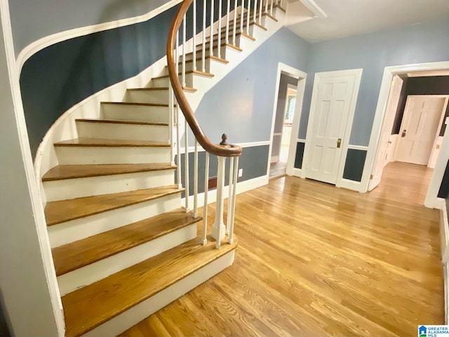 stairway with hardwood / wood-style flooring