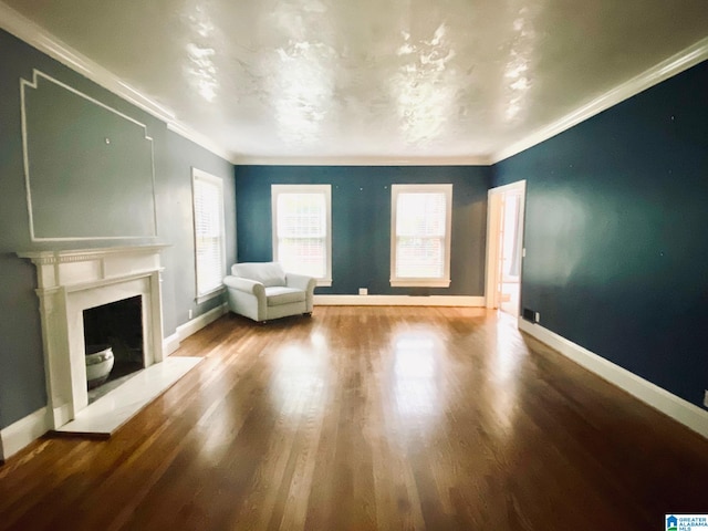 unfurnished living room with ornamental molding and hardwood / wood-style floors