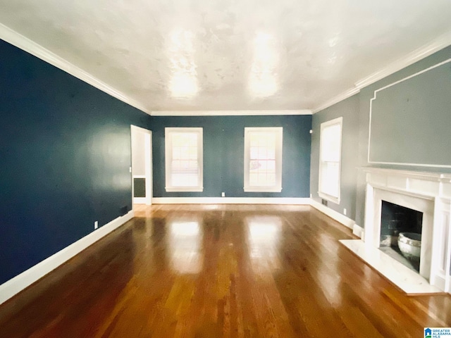 unfurnished living room with ornamental molding, a high end fireplace, and hardwood / wood-style flooring