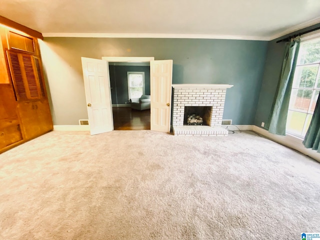 unfurnished living room featuring carpet floors, crown molding, and a brick fireplace