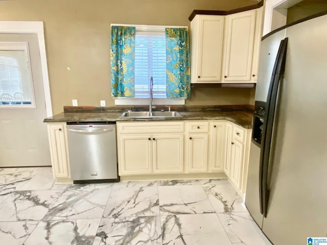 kitchen featuring cream cabinetry, appliances with stainless steel finishes, and sink