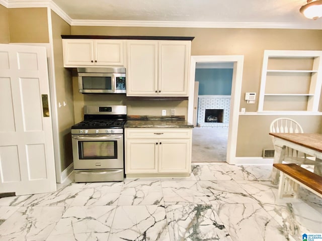 kitchen with a fireplace, stainless steel appliances, and ornamental molding