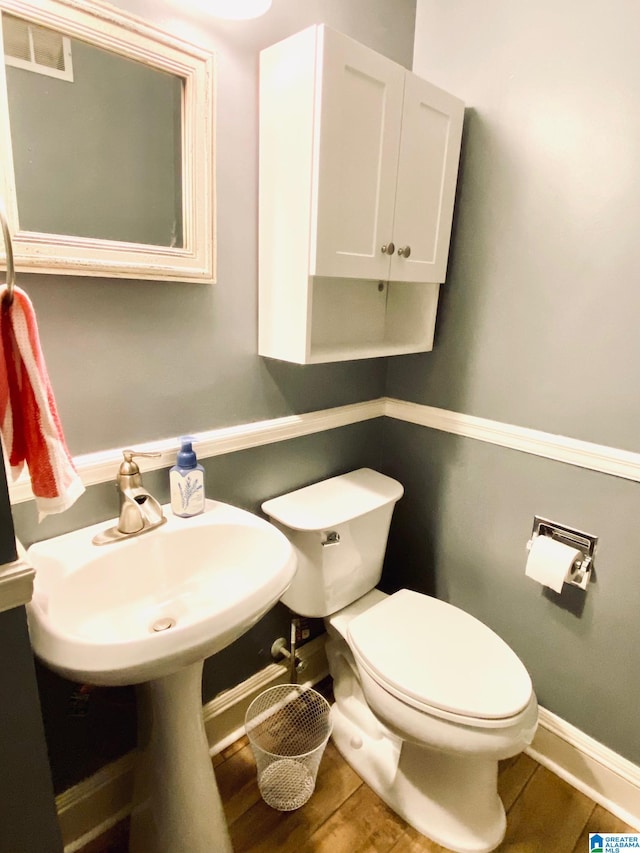 bathroom featuring toilet, hardwood / wood-style flooring, and sink