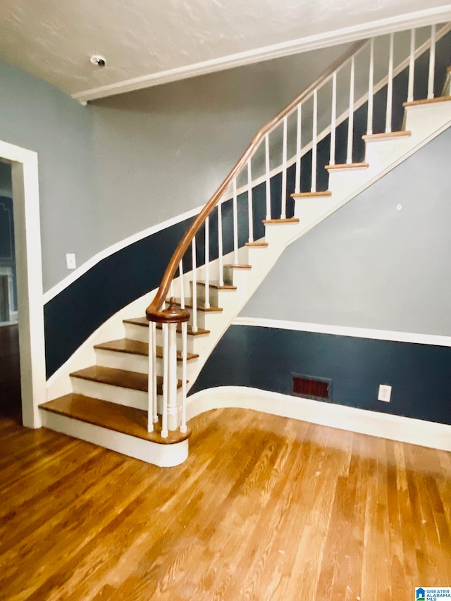 stairs featuring wood-type flooring