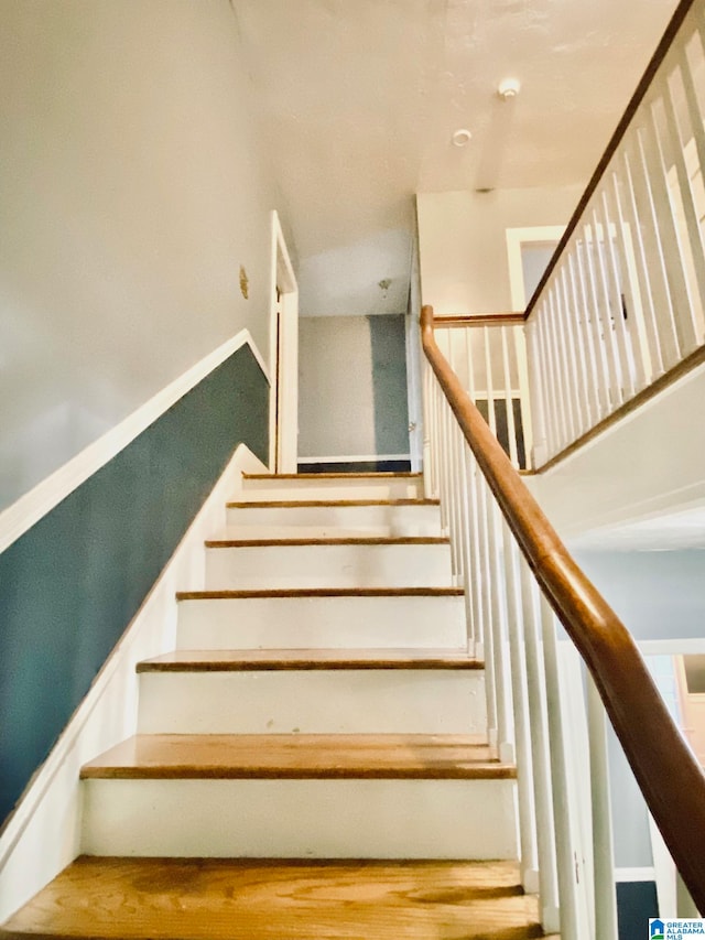 staircase with hardwood / wood-style flooring