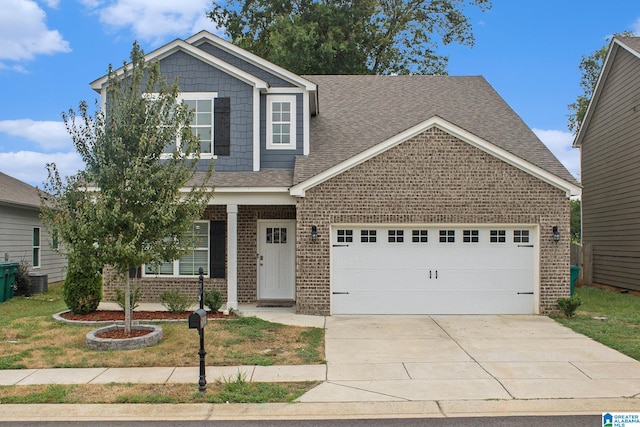 craftsman-style house with a garage and a front lawn