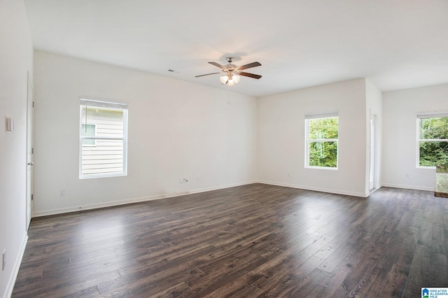 empty room with ceiling fan and dark hardwood / wood-style floors