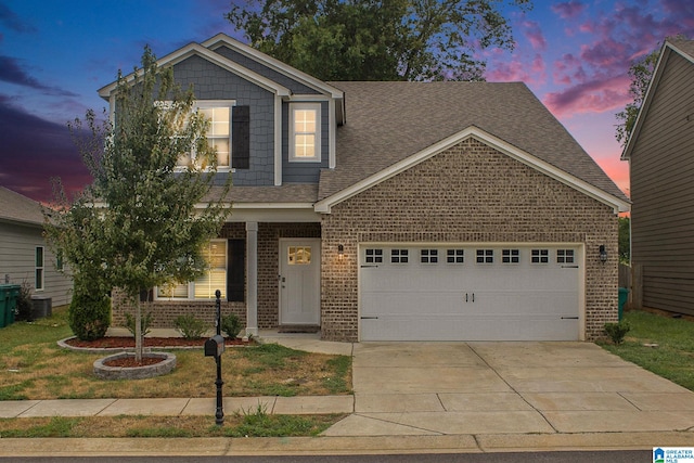 craftsman house with a garage and a yard